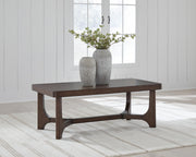Ashley Furniture Korestone living room occasional table set with three modern, round tables featuring wood and metal finishes.