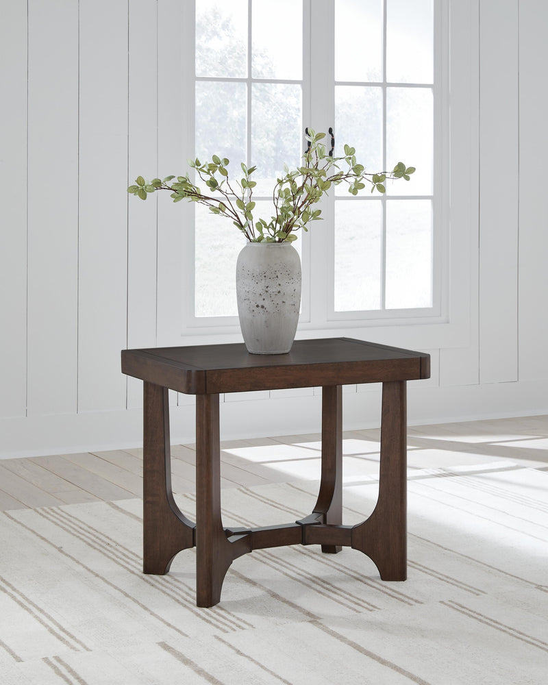 Ashley Furniture Korestone living room occasional table set with three stylish tables featuring sleek designs and wood finishes.
