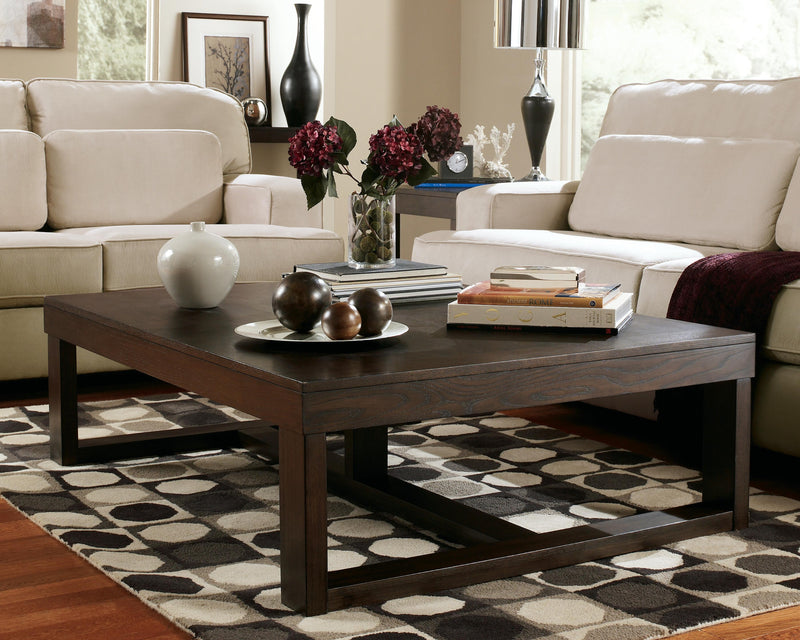 Ashley Furniture Watson occasional table set with two round tables featuring wooden tops and tapered legs.