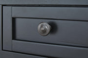 Wildenauer lift-top Ashley Furniture cocktail table with a warm wood finish and detailed knob hardware, showing the lift mechanism.
