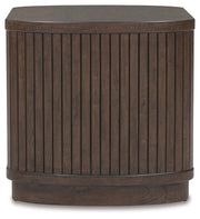Ashley Furniture Korestone end table with a sleek wooden surface and modern design, shown from a side view.