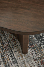 Ashley Furniture Korestone cocktail coffee table with a sleek, detailed wooden top and modern design.