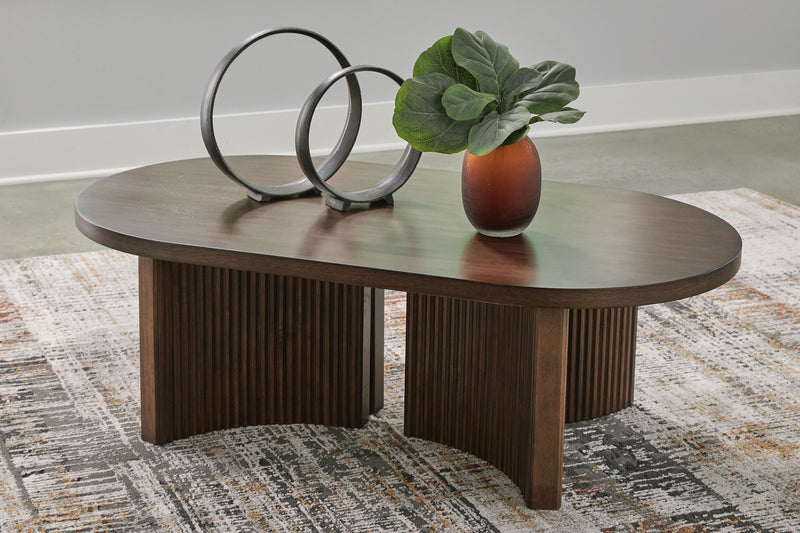Ashley Furniture Korestone coffee table, modern cocktail table with a sleek design and wooden finish, shown in T689-0.jpg.