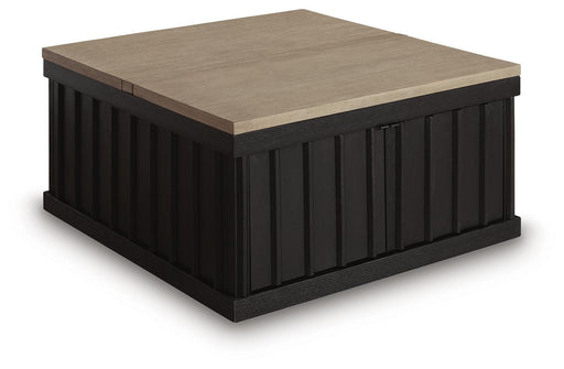 Ashley Furniture Rylandyn lift-top cocktail table with a closed, angled view showing its sleek wooden finish and versatile design.