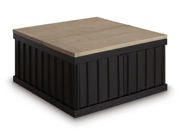 Ashley Furniture Rylandyn lift-top cocktail coffee table with closed top and angled side view, showcasing its sleek design and lift mechanism.