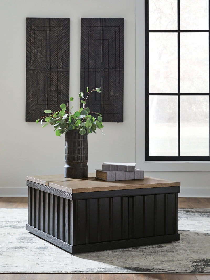 Ashley Furniture Rylandyn lift-top cocktail table with a closed wood surface and storage space, shown in a cropped view.