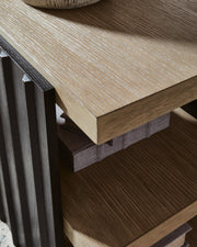 Close-up of the Rylandyn end table by Ashley Furniture, showing its detailed wood finish and stylish tabletop design.