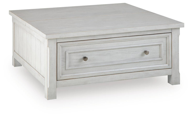 Ashley Furniture Robbinsdale lift-top coffee table with angled closed lid, showing its stylish wooden finish and functional design.