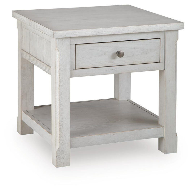 Ashley Furniture Robbinsdale end table with a closed drawer and angled design, featuring a warm wood finish and modern style.