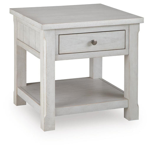 Ashley Furniture Robbinsdale end table with a closed drawer and angled design, featuring a warm wood finish and modern style.