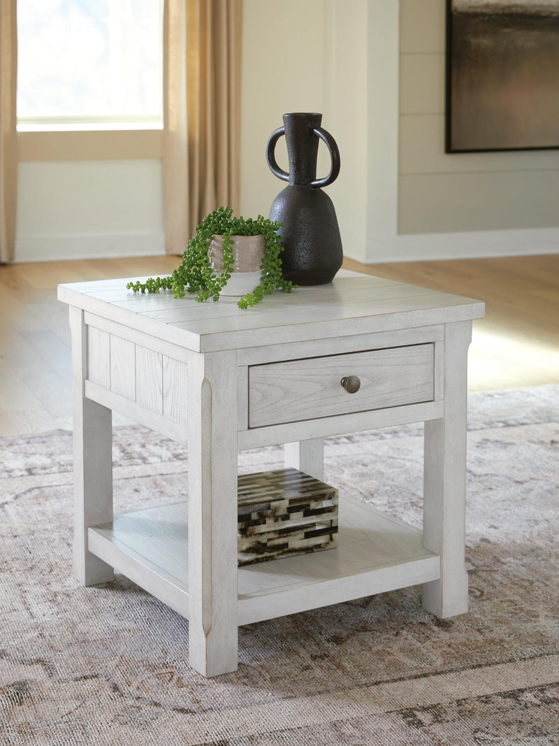 Ashley Furniture Robbinsdale end table with a wooden finish, featuring a rectangular top and sturdy legs for living room decor.