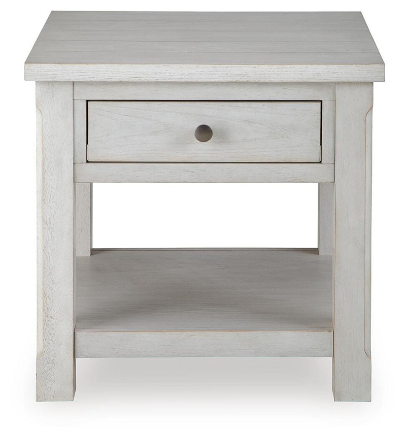 Ashley Furniture Robbinsdale End Table featuring a wooden top and tapered legs, shown from a head-on angle.