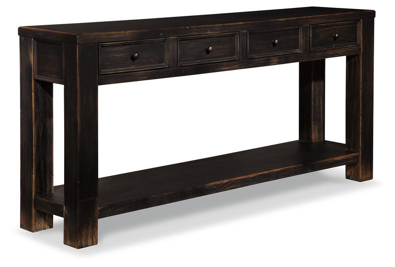 Ashley Furniture Gavelston sofa/console table with a sleek wood finish and modern design, featuring a spacious top and sturdy legs.