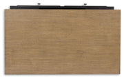 Ashley Furniture Drazmine lift-top cocktail table with a sleek wooden top and storage space, shown in a modern living room setting