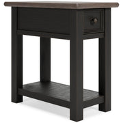 Ashley Furniture Tyler Creek occasional table set with two wood tables, one round and one rectangular, in a cozy living room setting.