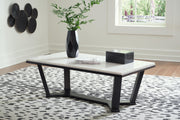 Ashley Furniture Fostead coffee cocktail table with a wooden finish and sleek design, shown in a modern living room setting.