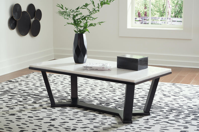 Ashley Furniture Fostead coffee cocktail table with a wooden finish and sleek design, shown in a modern living room setting.