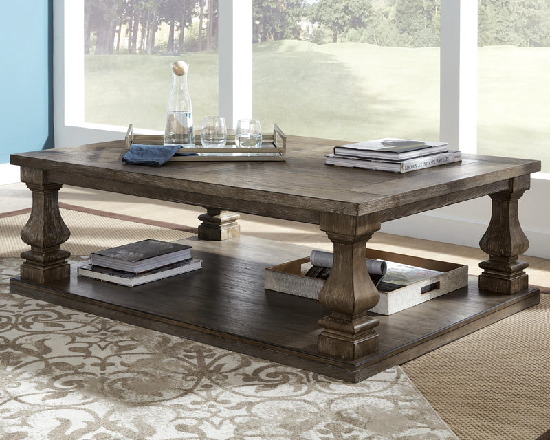 Ashley Furniture Johnelle coffee table with a sleek wooden surface and modern design, shown as a stylish cocktail table.