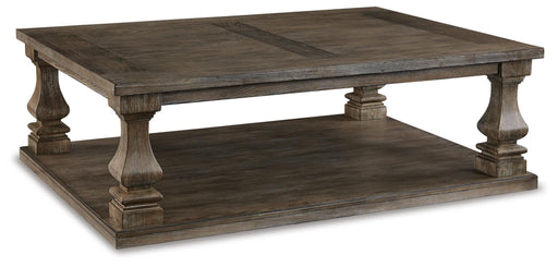 Ashley Furniture Johnelle coffee table, modern cocktail table with a sleek wooden finish, shown from an angled side view.