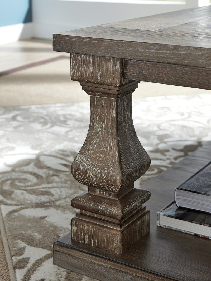 Ashley Furniture Johnelle occasional table set showing two stylish wood tables with metal accents and a modern design.