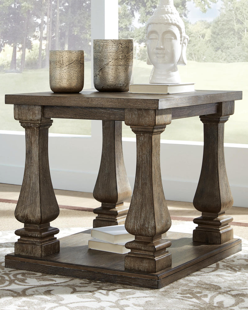 Ashley Furniture Johnelle occasional table set featuring three stylish tables with sleek wood finishes and modern design.