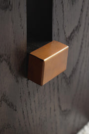 Ashley Furniture Burkhaus cocktail coffee table with sleek wooden surface and modern design, shown in detailed view.