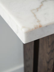 Ashley Furniture Burkhaus sofa table with a sleek wooden surface and metal legs, perfect for living room decor.