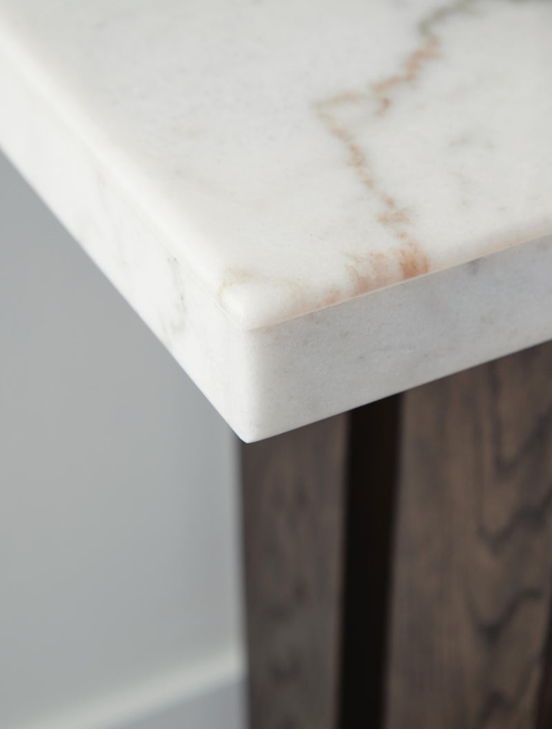 Ashley Furniture Burkhaus sofa table with a sleek wooden surface and metal legs, perfect for living room decor.