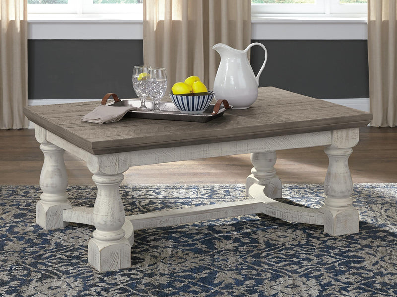 Ashley Furniture Havalance coffee table with a sleek wooden top and metal legs, serving as a stylish cocktail table.