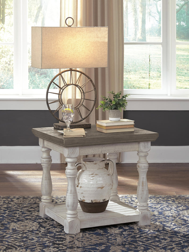 Ashley Furniture Havalance end table with a wooden top and metal frame, featuring a modern design and sleek finish.