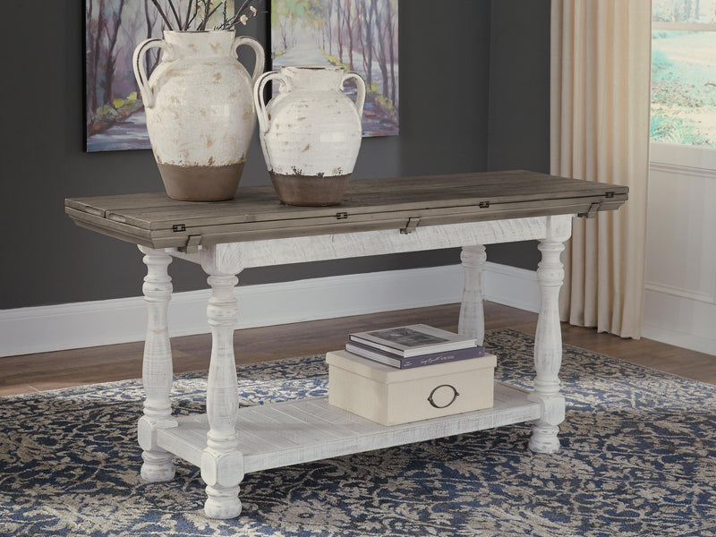 Ashley Furniture Havalance sofa table featuring a sleek design with a dark wood finish, perfect for living room decor.