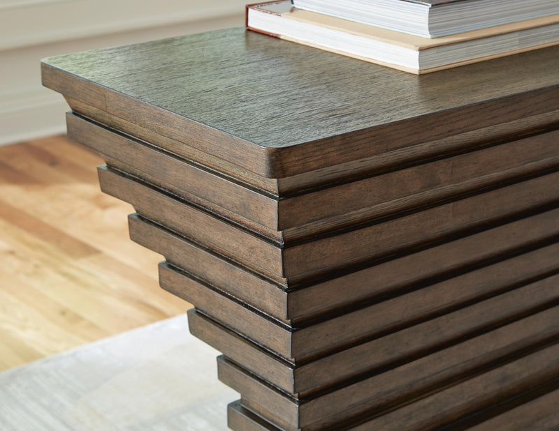 Ashley Furniture Hannodream sofa table featuring a sleek wood surface and modern design, perfect for living room decor.
