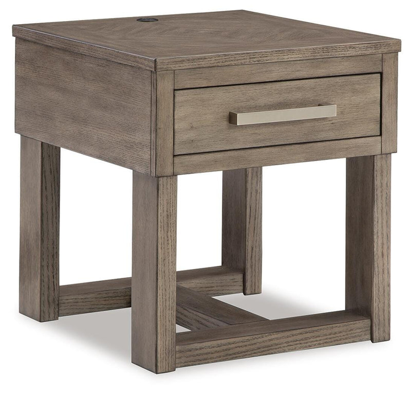 Ashley Furniture Loyaska occasional table set with three round wooden tables and tapered legs, shown from an angled view.
