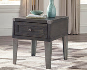 Ashley Furniture Todoe occasional table set featuring three modern tables with dark wood finishes and sleek metal legs.
