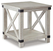 Ashley Furniture Carynhurst end table with a wooden top and tapered legs, shown from an angled side view.