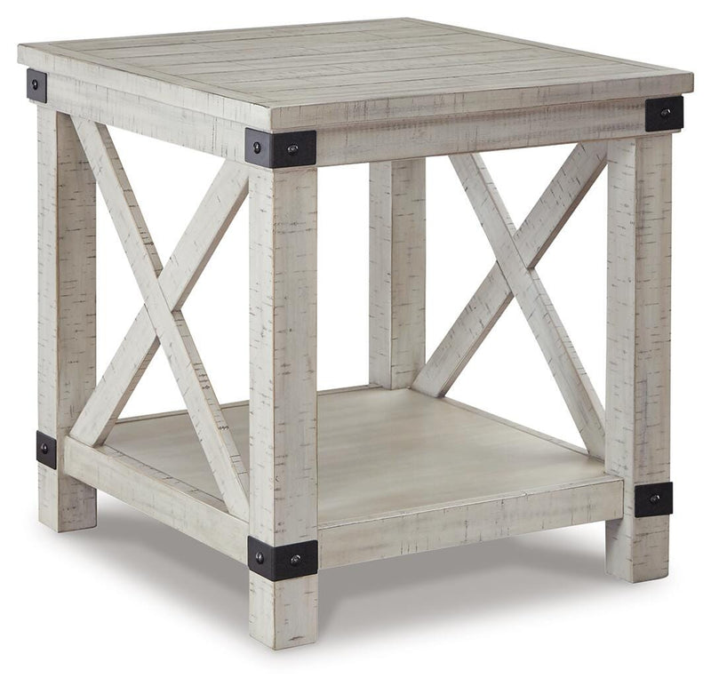 Ashley Furniture Carynhurst end table with a wooden top and tapered legs, shown from an angled side view.