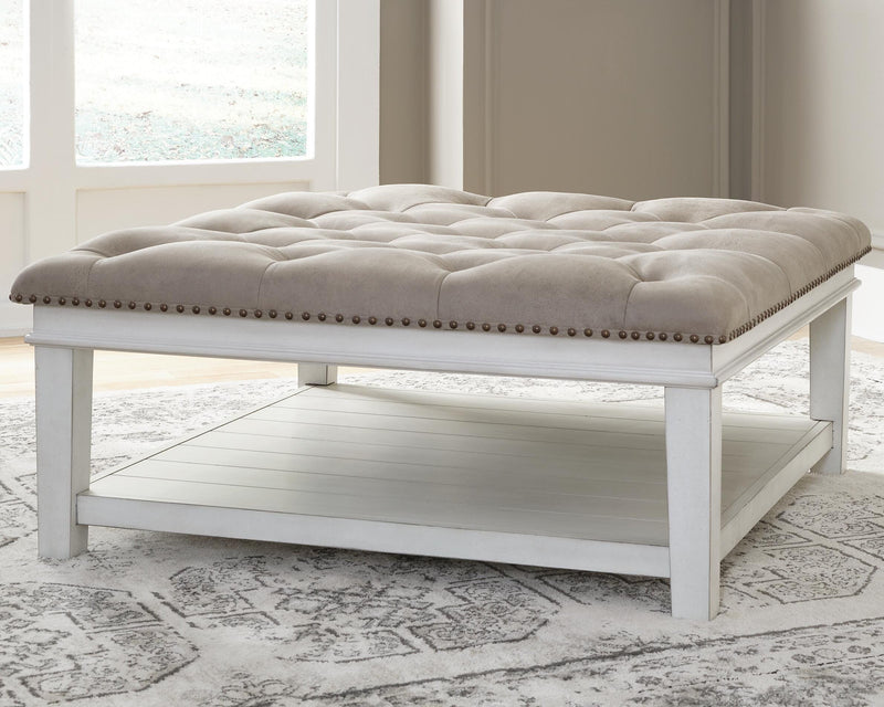 Ashley Furniture Kanwyn upholstered cocktail ottoman coffee table with cushioned top and wooden legs, modern and versatile design