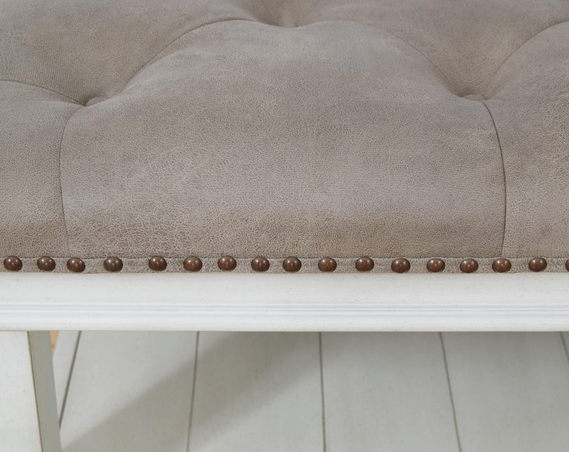 Ashley Furniture Kanwyn upholstered ottoman coffee table with fabric upholstery and wooden legs, versatile living room accent piece.