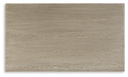 Ashley Furniture Dalenville cocktail coffee table with a sleek wooden top and modern design, shown from a top view.