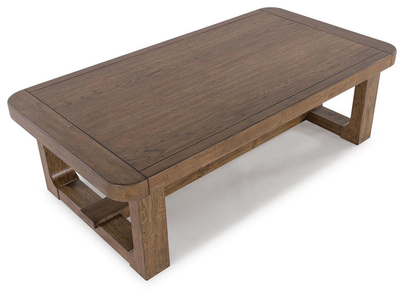 Cabalynn Ashley Furniture cocktail coffee table with wooden top and metal legs, angled view showcasing modern design.