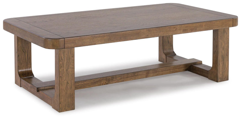 Ashley Furniture Cabalynn cocktail table with a sleek wooden top and metal legs, shown from an angled side view.