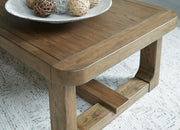 Ashley Furniture Cabalynn cocktail table with a dark wood finish and sleek metal legs, detailed close-up of the modern design.