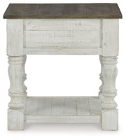Ashley Furniture Havalance End Table with a sleek wooden surface and modern design, shown in a cozy living room setting.
