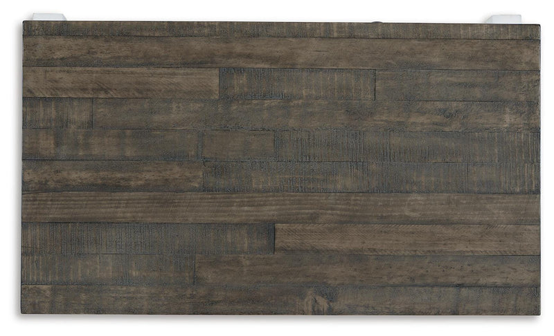 Ashley Furniture Havalance lift-top coffee table with a sleek wooden surface and hidden storage in a modern living room setting.