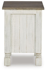 Ashley Furniture Havalance chairside end table with a modern design, featuring a dark wood finish and a compact, functional surface.