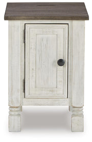 Ashley Furniture Havalance chairside end table with a dark wood finish and a single drawer, shown from a head-on angle.