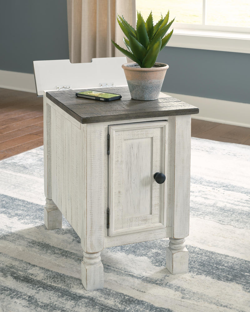 Ashley Furniture Havalance chairside end table with open lid, showcasing a wooden surface and storage compartment.