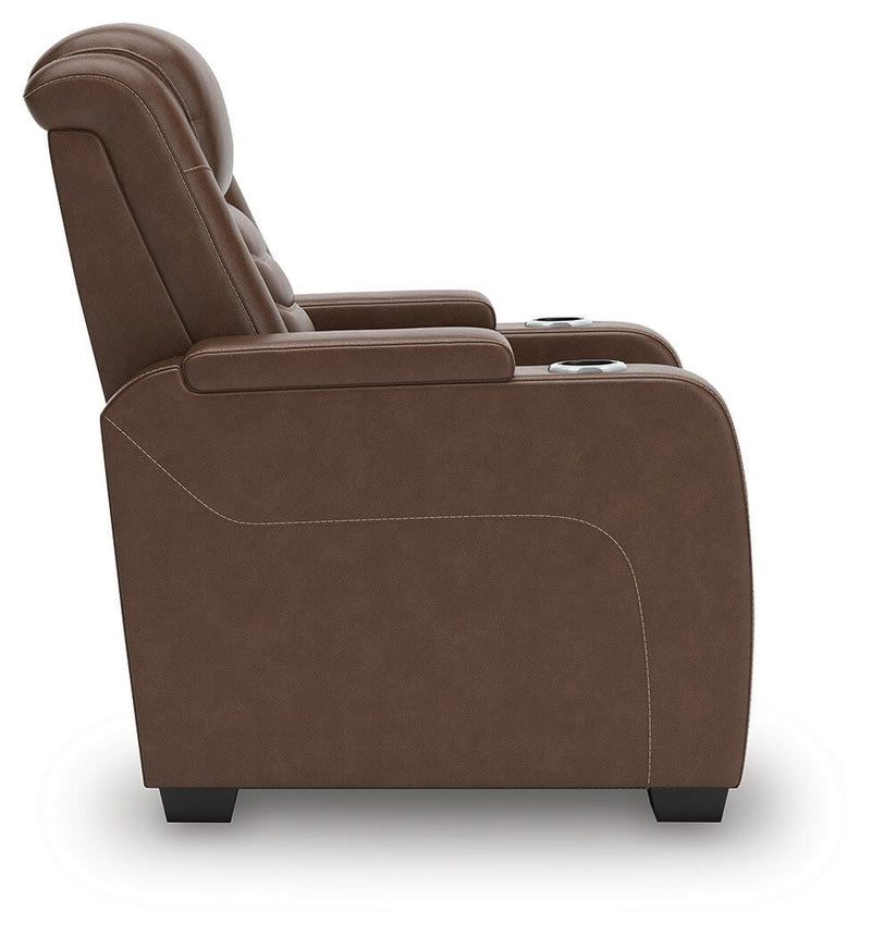 Ashley Furniture high impact power recliner shown from the side with padded armrests and plush cushioning for comfort.