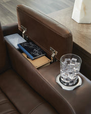 Ashley Furniture high impact power recliner with cushioned armrests and sturdy frame, shown in a modern living room setting.