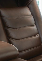 Ashley Furniture high impact power recliner with tufted upholstery, featuring plush cushioning and a modern design.